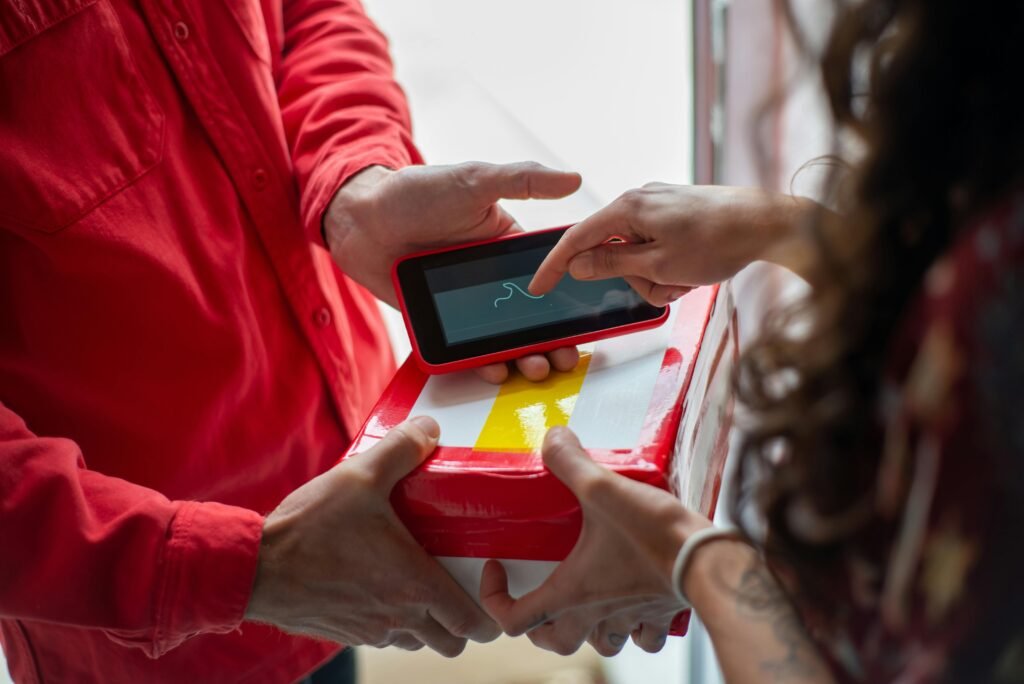 A customer signs for a package using a digital device, enhancing delivery efficiency.